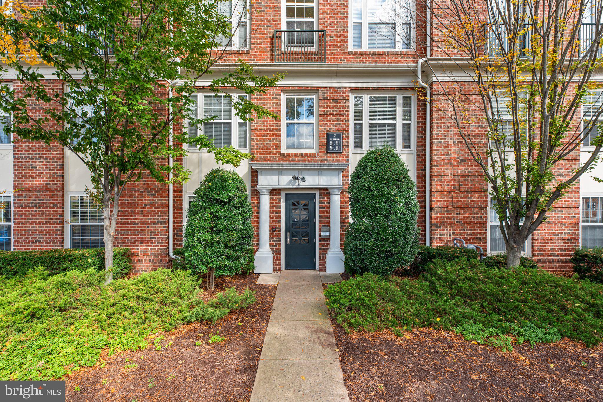 front view of a brick house with a yard