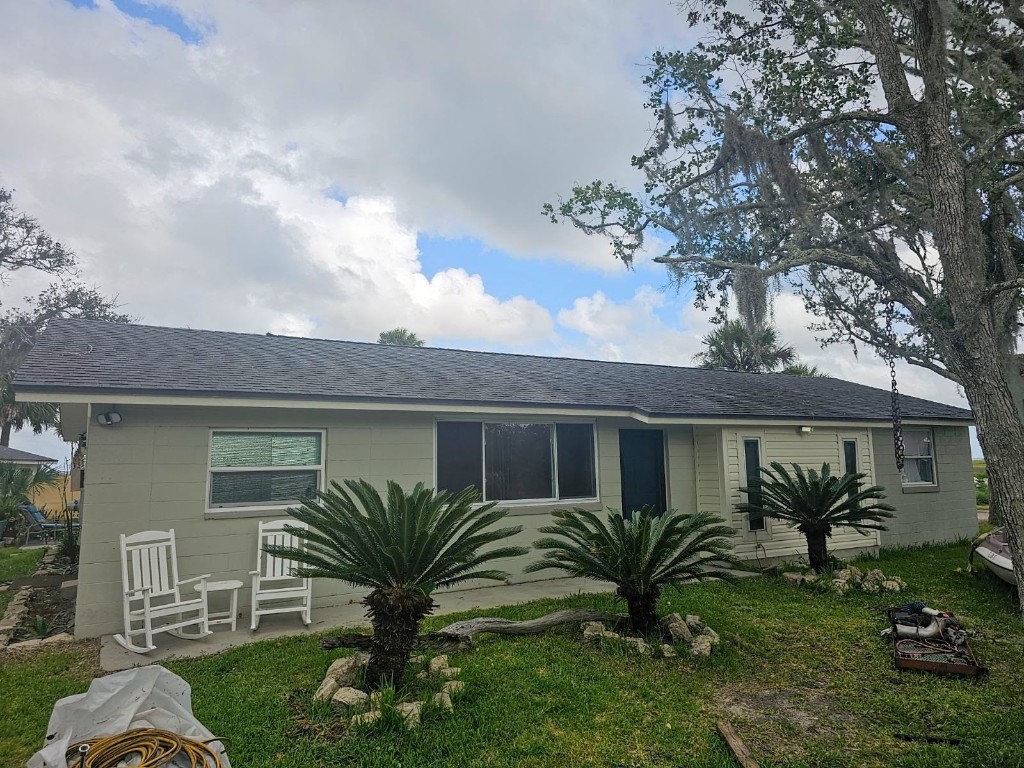 a view of a house with a backyard