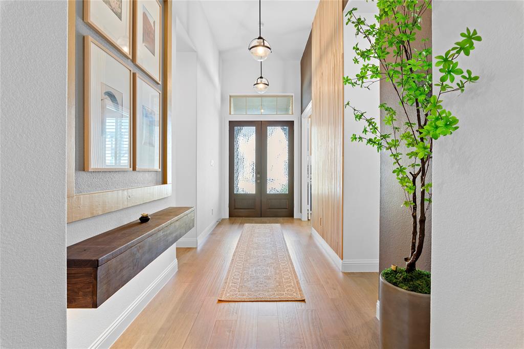 a hallway with a potted plant in front of a house