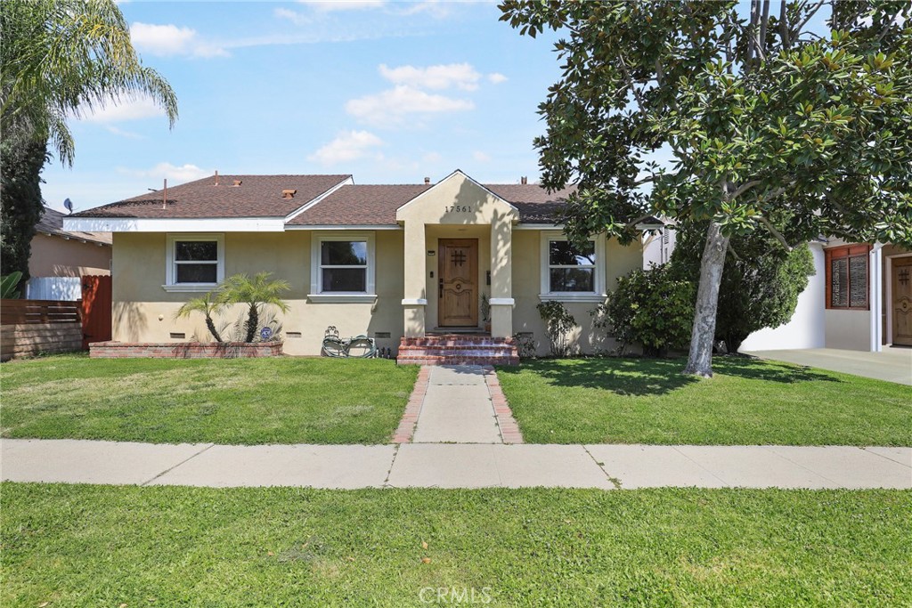 a front view of a house with a garden and patio