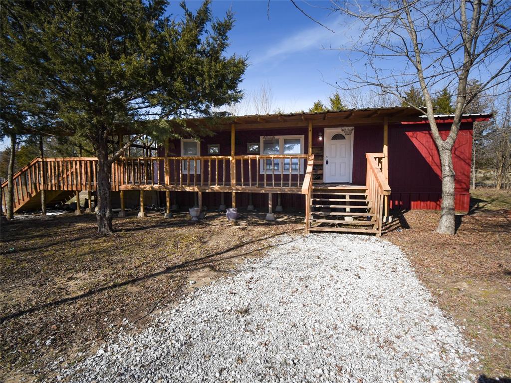 a view of a house with a yard and wooden fence