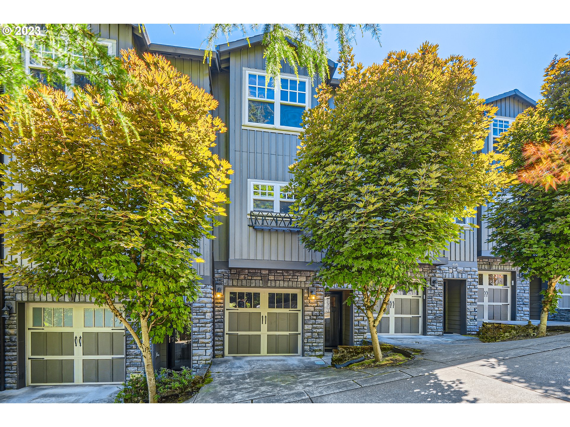 a view of a house with a tree and a yard