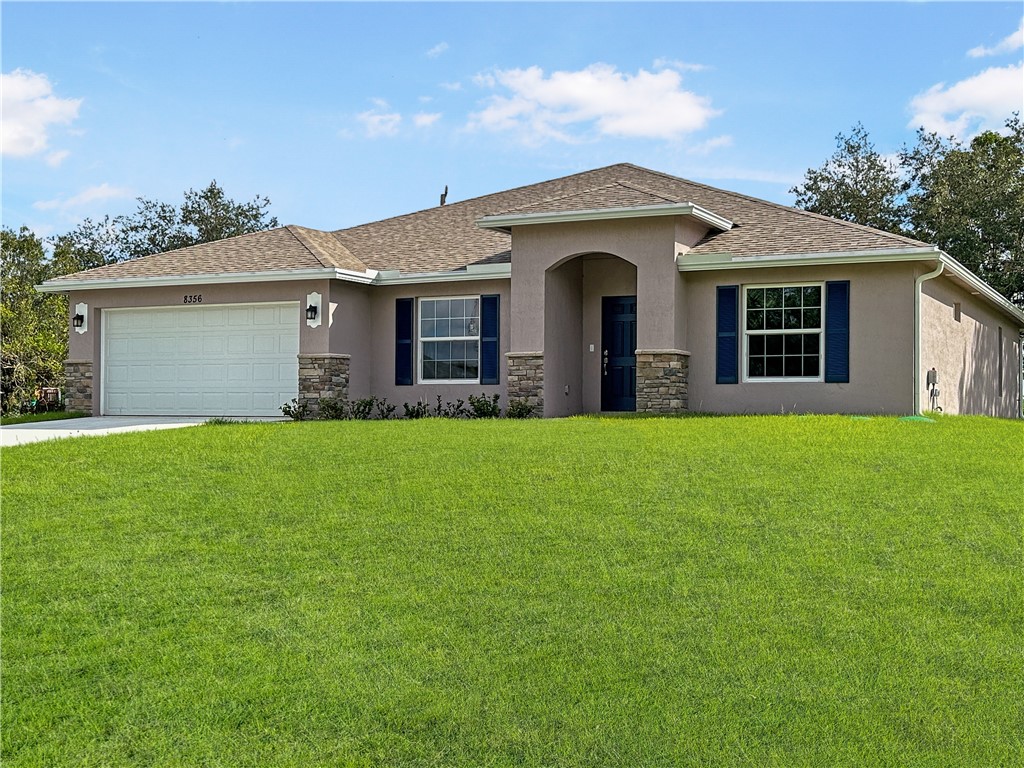 a front view of house with yard and green space