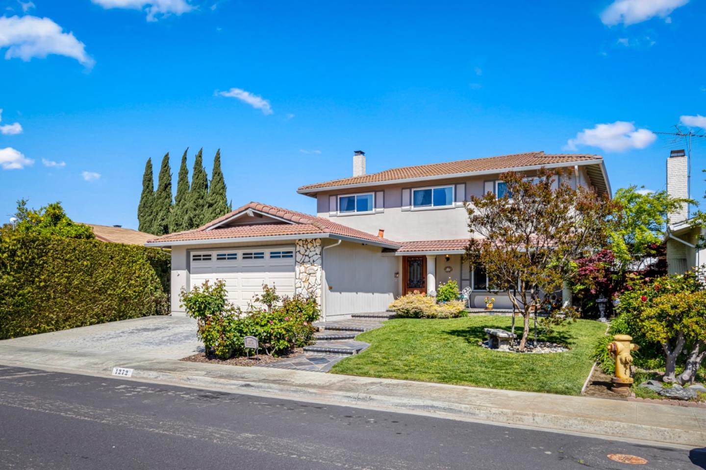 a front view of a house with a yard