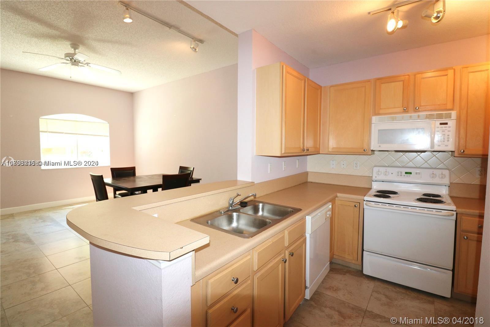 a kitchen that has a sink and a stove in it