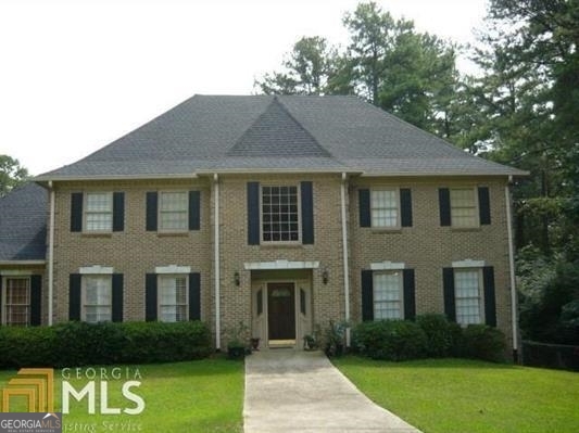 a front view of a house with garden