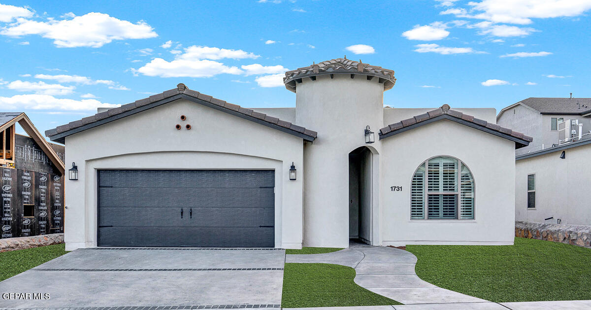 a front view of a house with a yard and garage