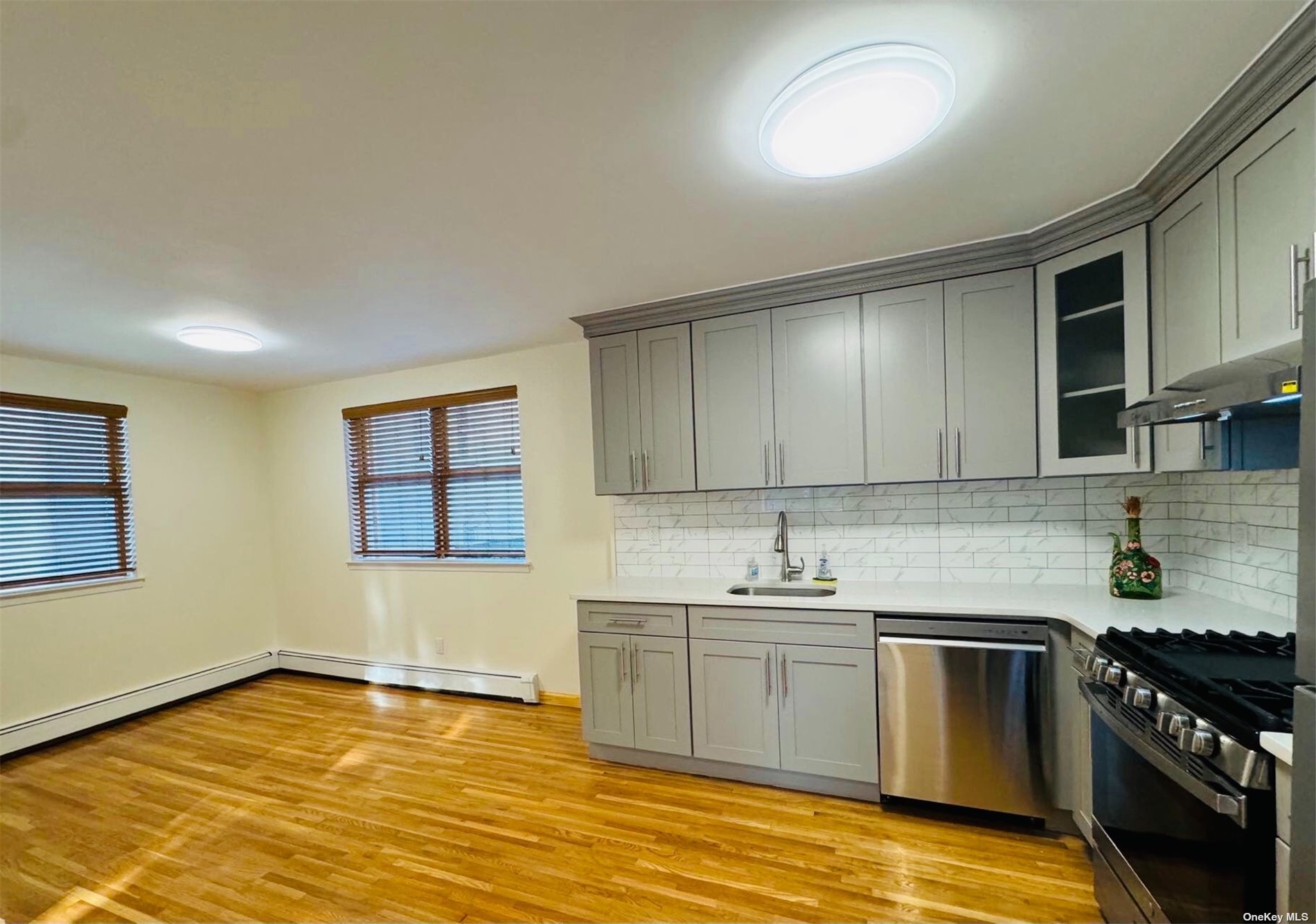 a kitchen with stainless steel appliances granite countertop a sink stove and cabinets