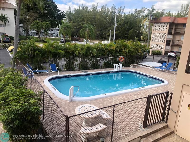 a view of a swimming pool with a patio