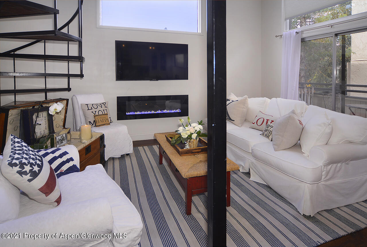 a bedroom with furniture and a fireplace