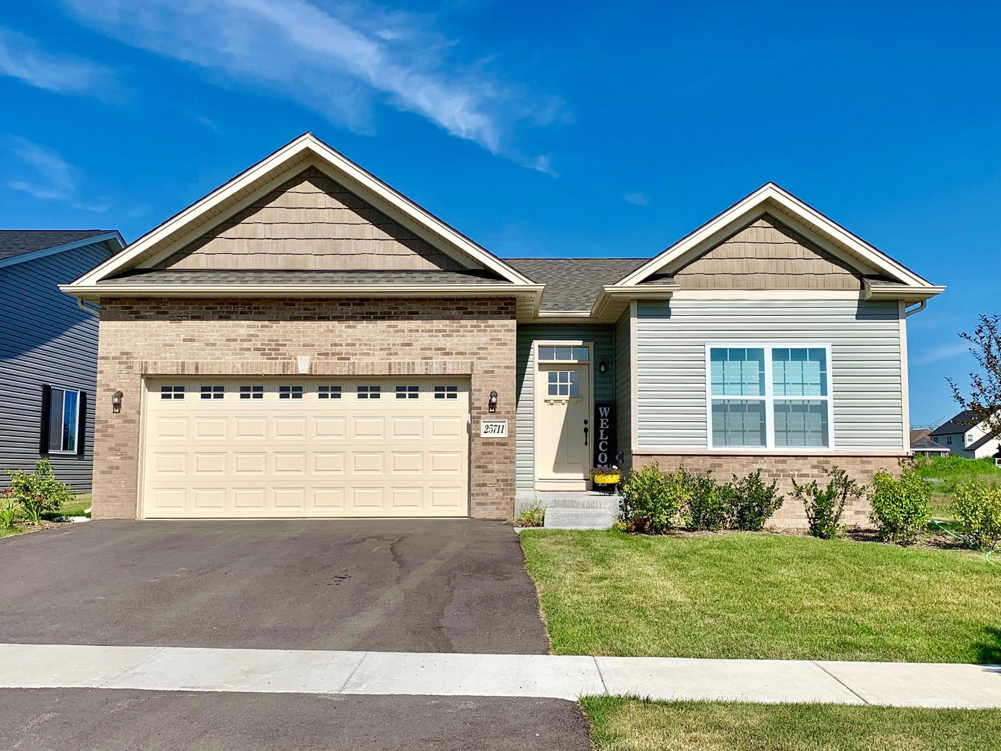 a front view of a house with a yard and garage