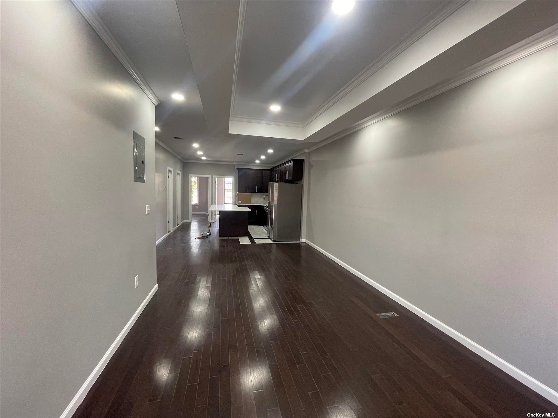 a view of empty room with wooden floor