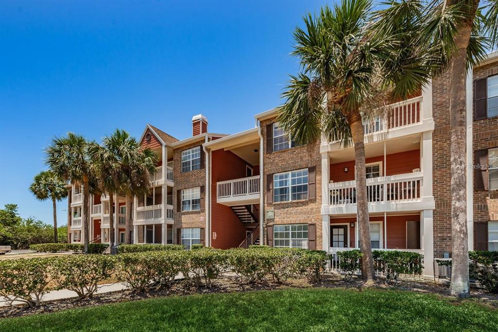 a front view of a residential apartment building with a yard