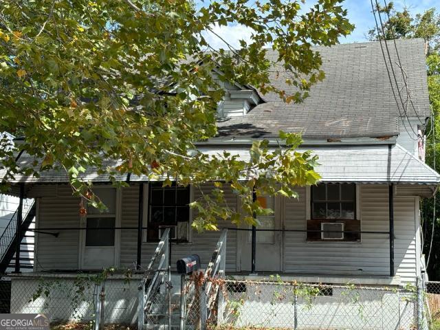 a view of a house with a tree