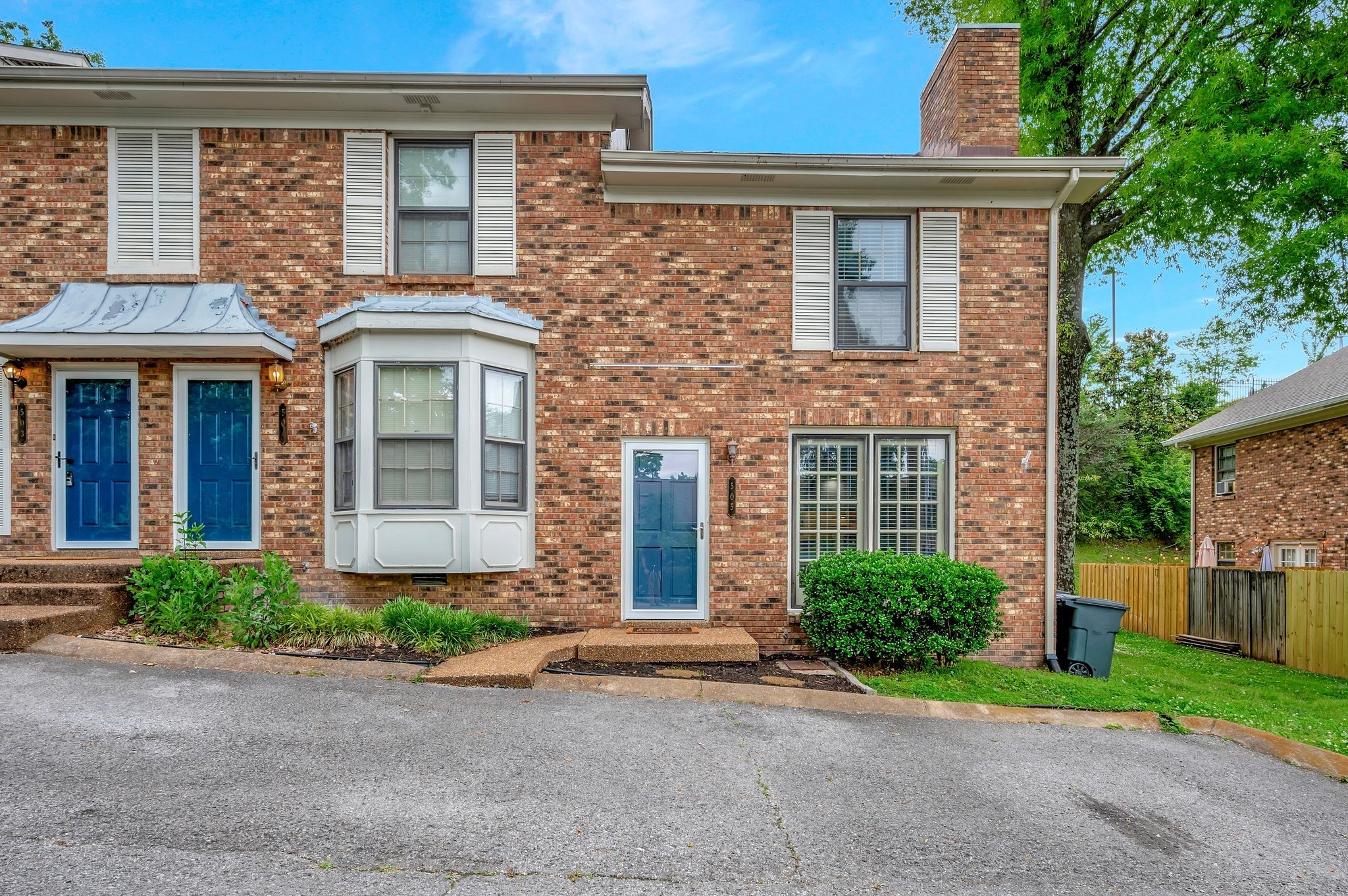 front view of brick house with a yard