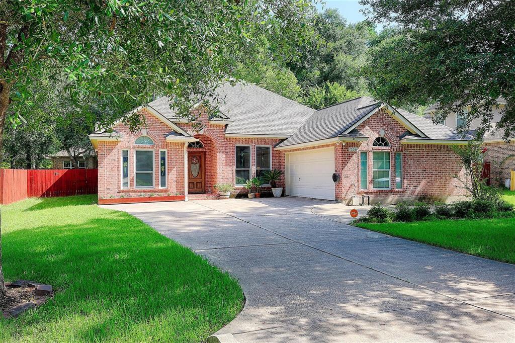 a front view of a house with a garden and yard