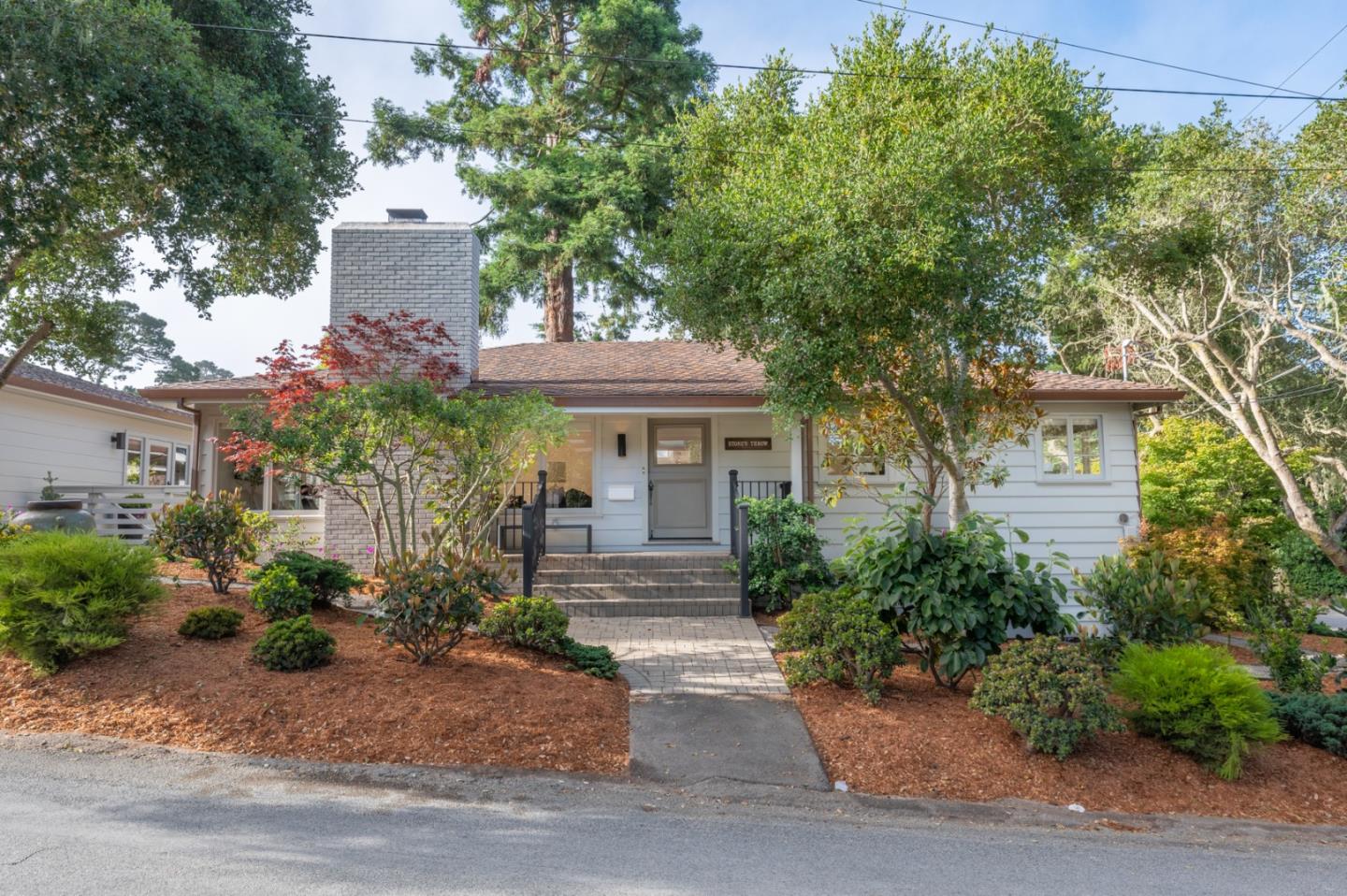 a front view of a house with garden