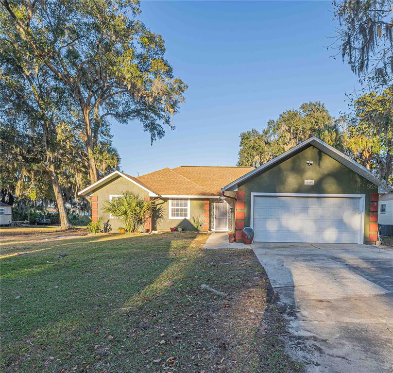 a front view of a house with a yard and garage