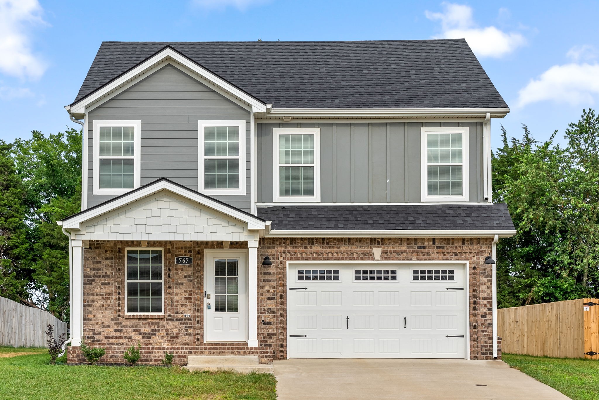 a front view of a house with a yard and garage