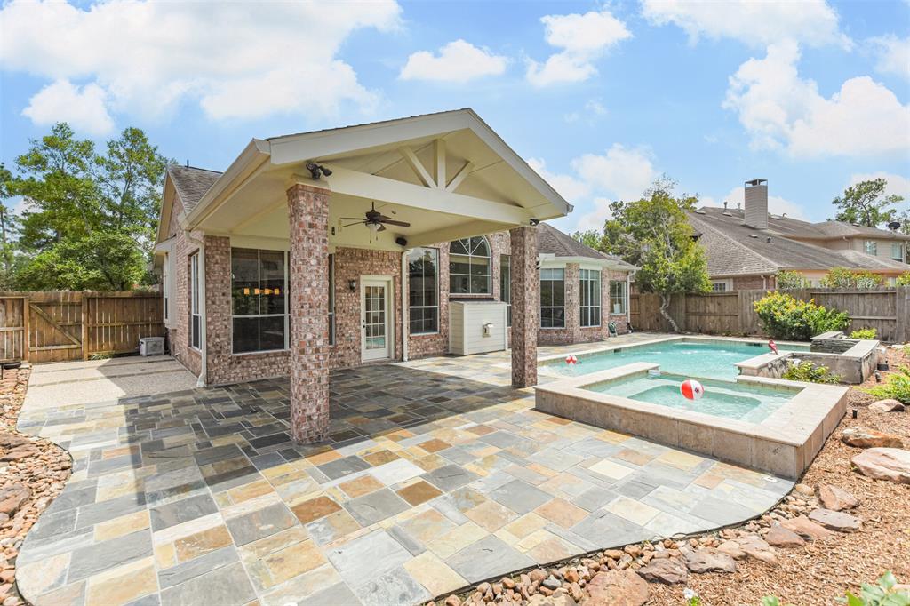 a view of house with swimming pool and sitting area