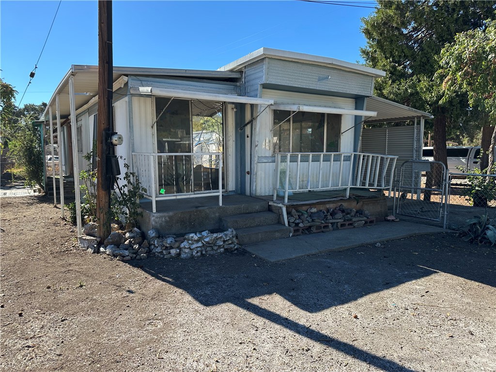 a view of a house with a small yard and wooden fence