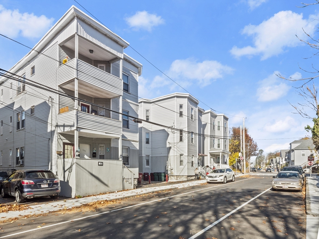 a view of a street with a building in the background