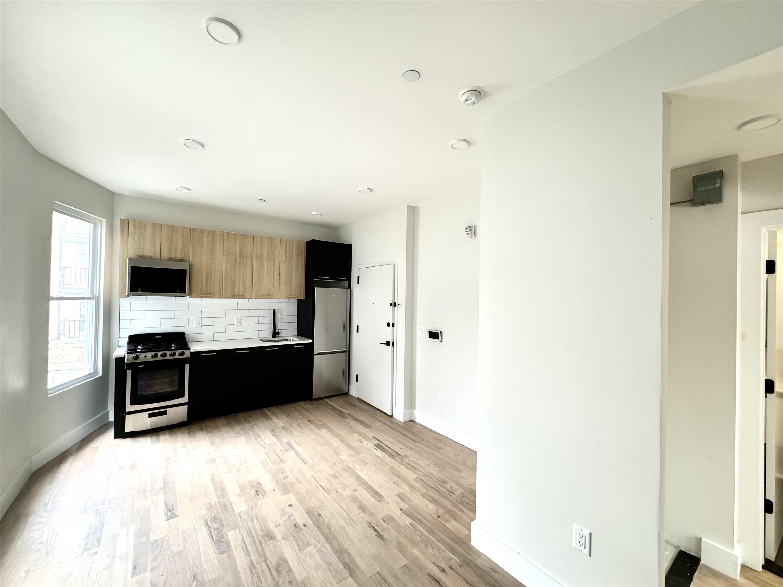 a large kitchen with a large counter top space and stainless steel appliances