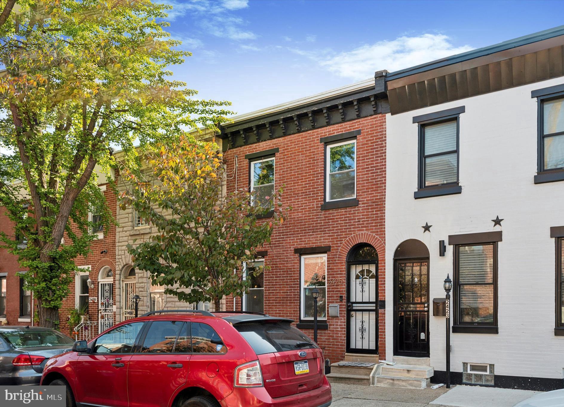 a front view of a house with parking area