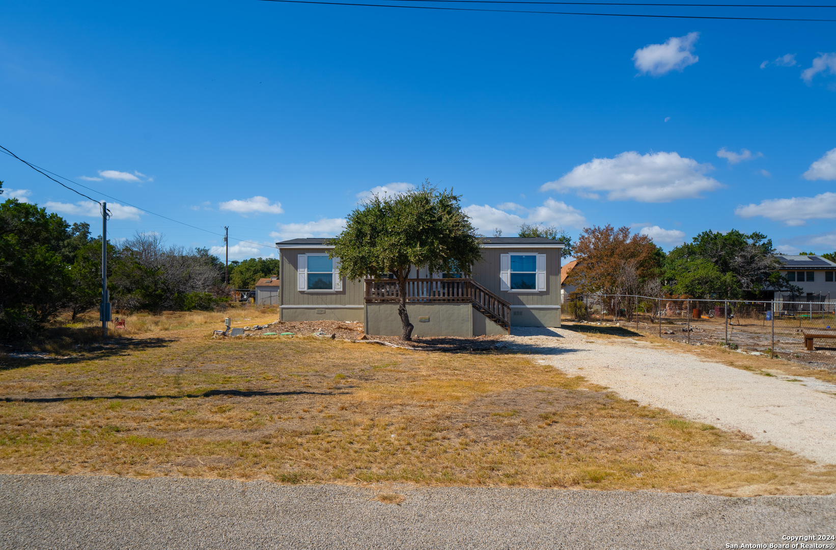 a view of a house with yard and sitting area