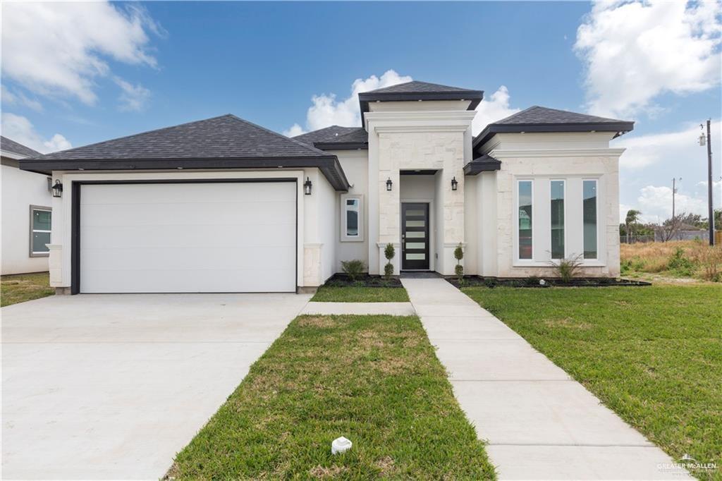 a front view of a house with a yard