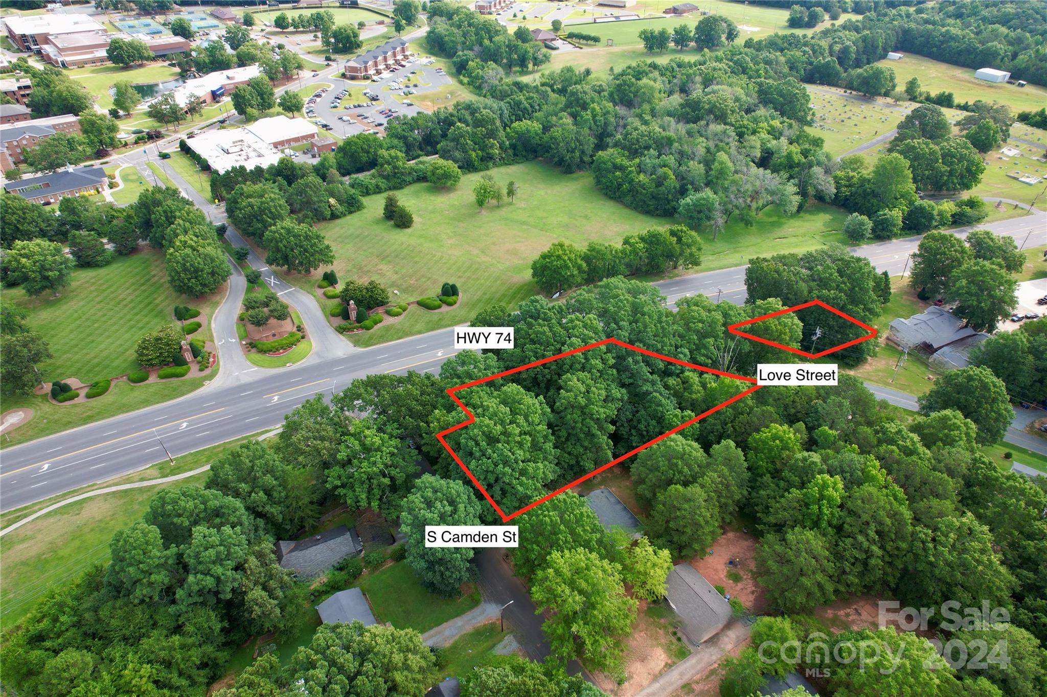 an aerial view of a residential houses with outdoor space and street view