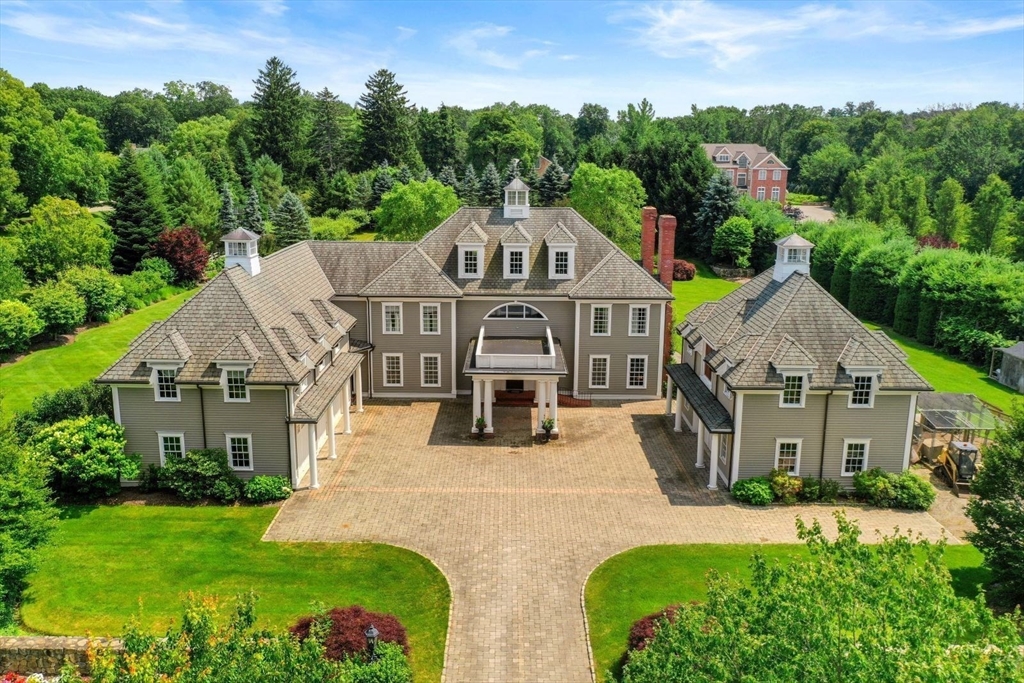 an aerial view of a house with yard and green space