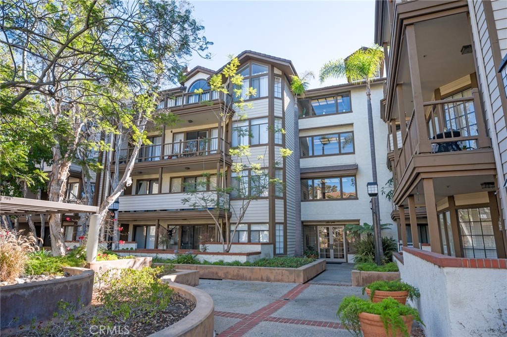 a front view of a residential apartment building with a yard