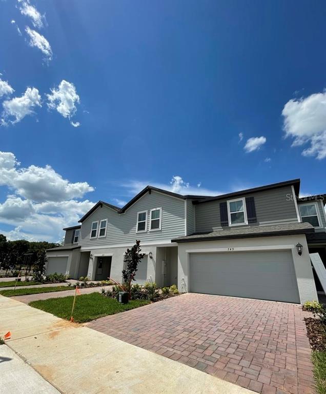 a view of a house with a yard and garage