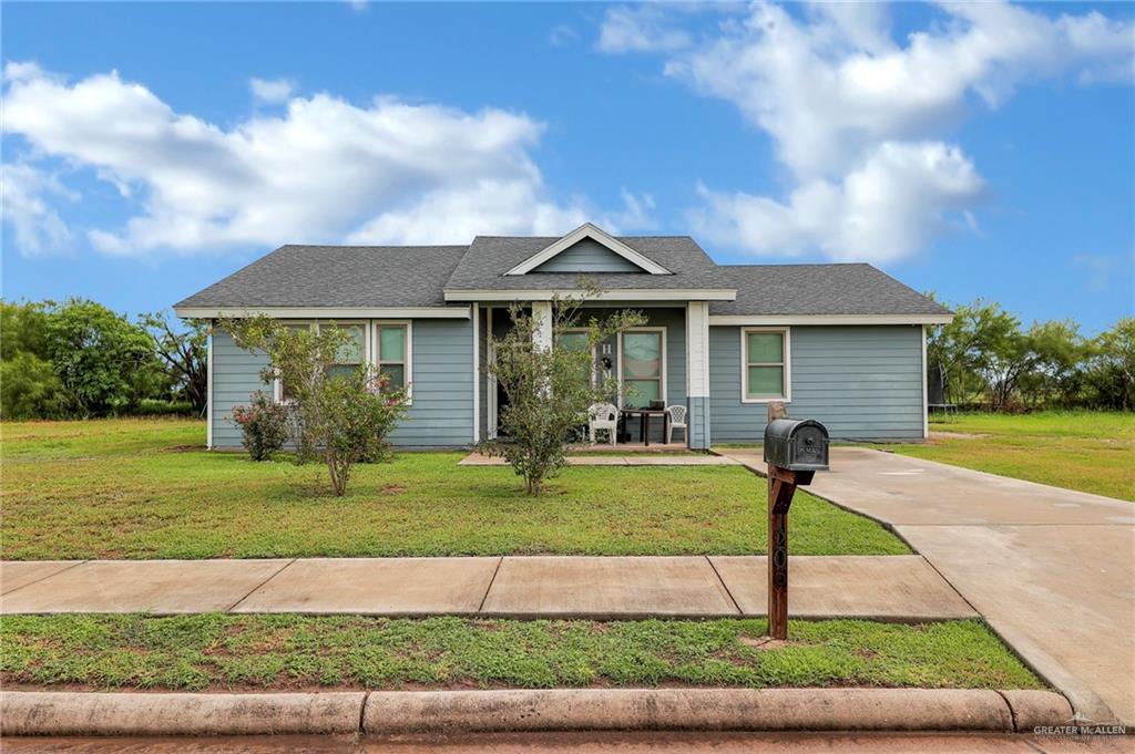 a front view of a house with a yard and porch