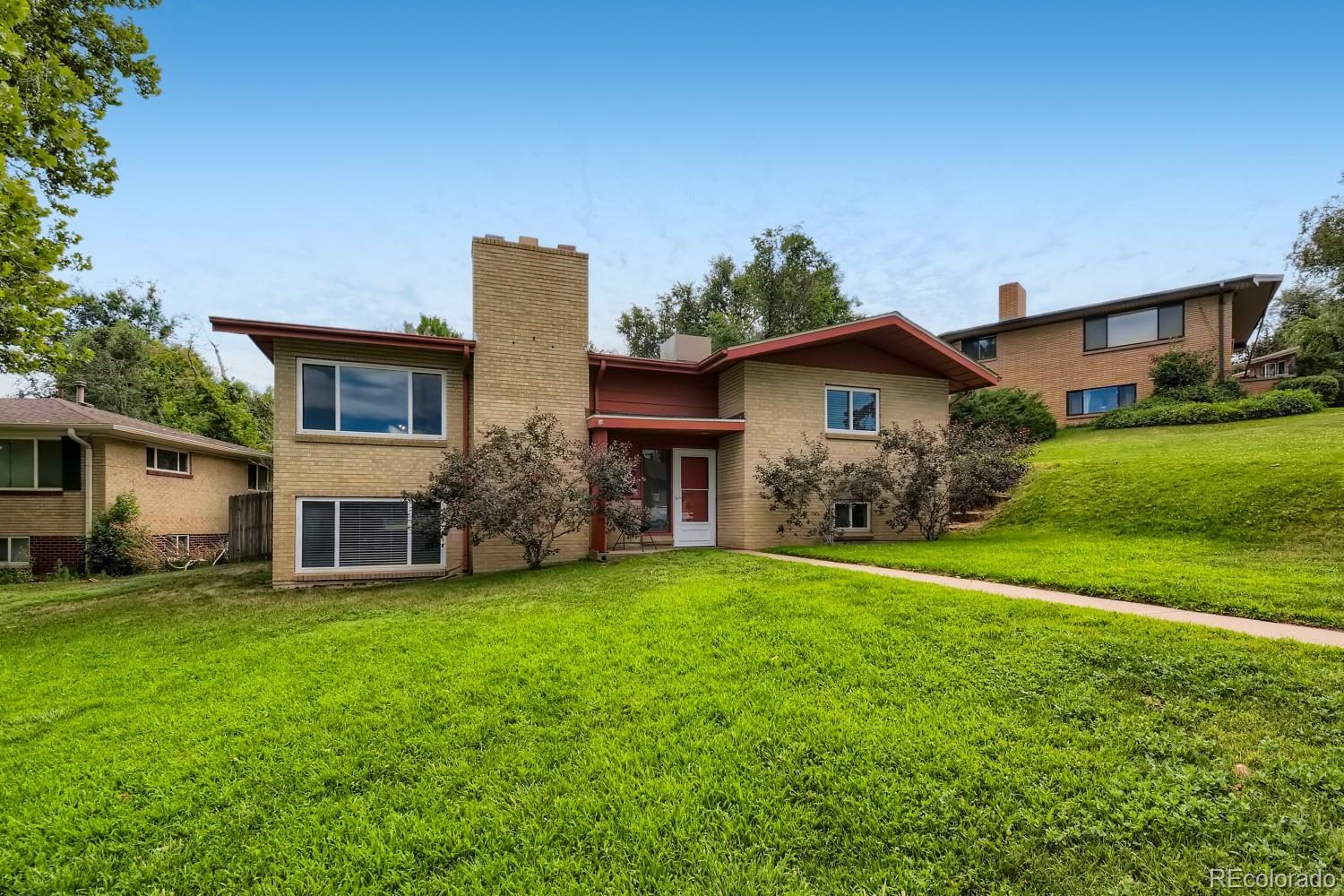 a front view of house with yard and green space