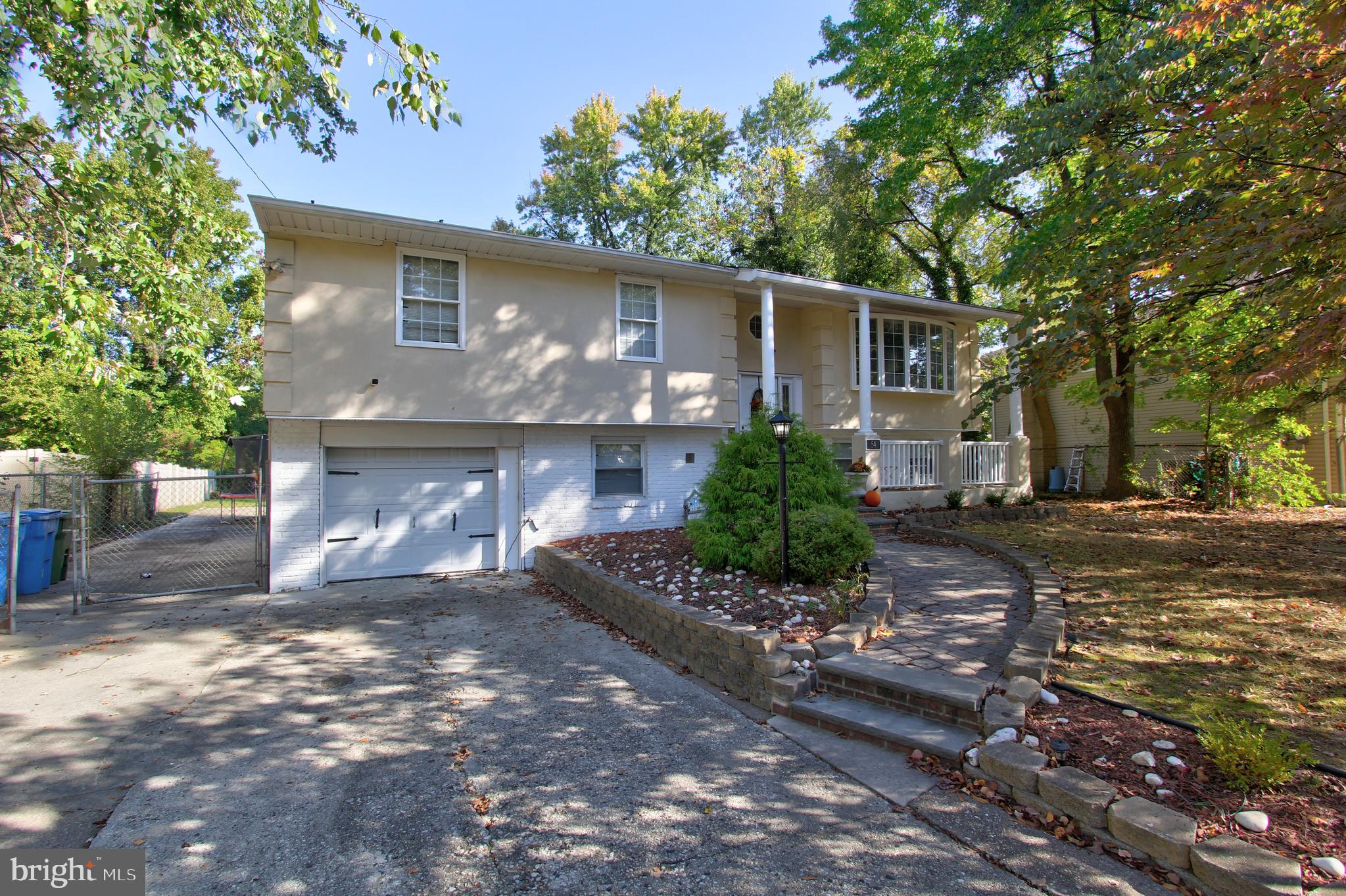 a front view of a house with a yard and a garage