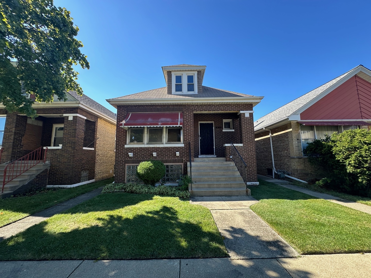 a front view of a house with a yard and porch