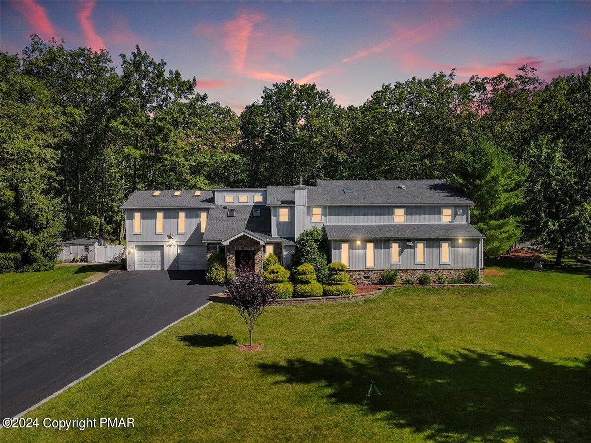 a view of a house with backyard and sitting area