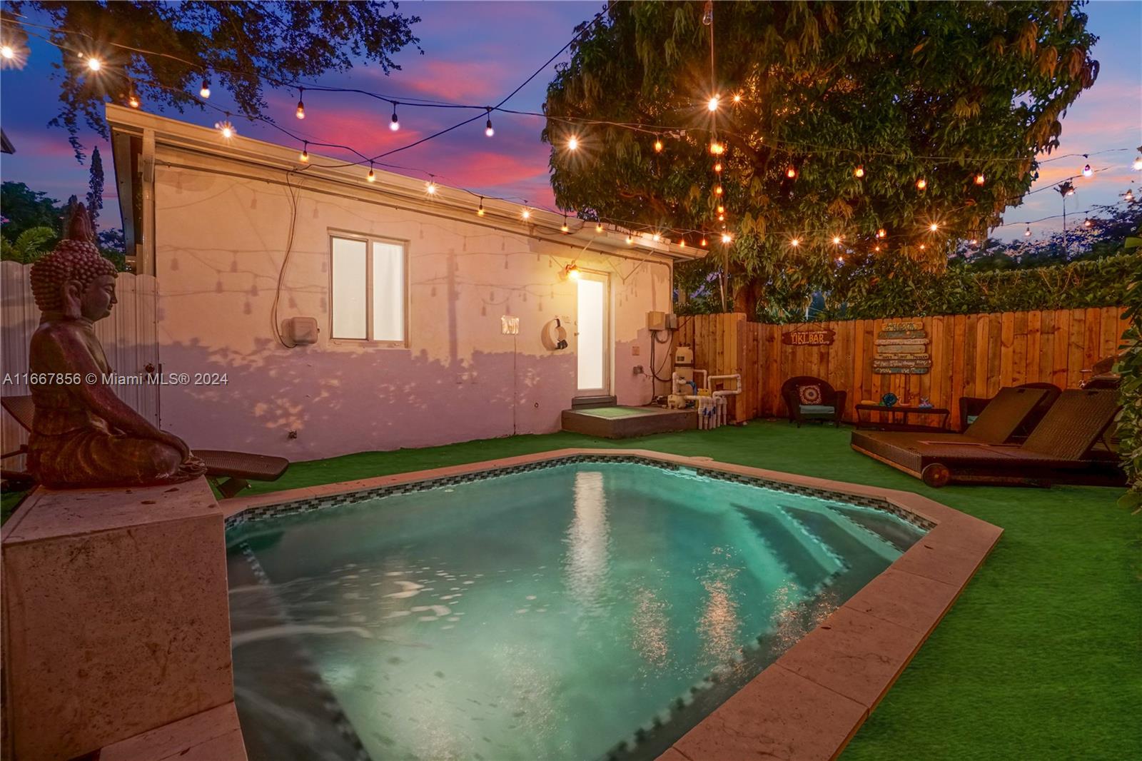 a view of a backyard with swimming pool