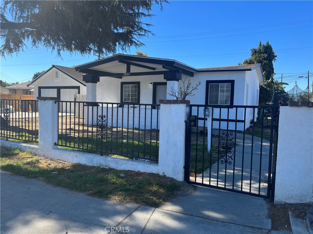 a view of a house with a wooden fence