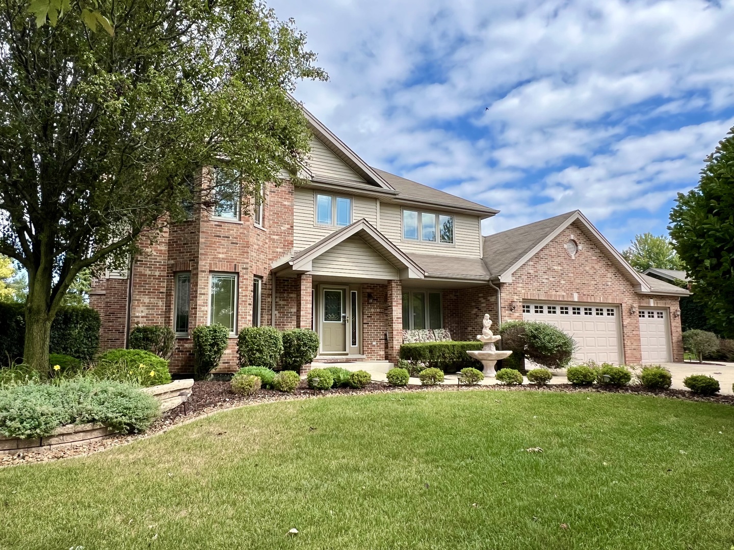 a front view of a house with garden