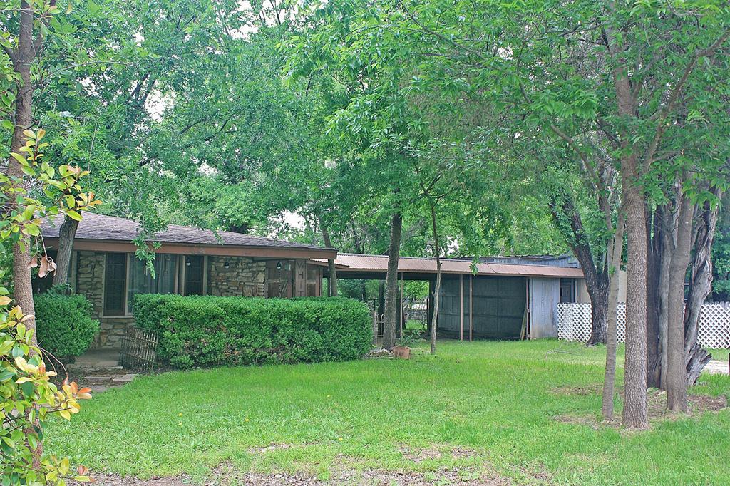 a view of an house with backyard space and garden