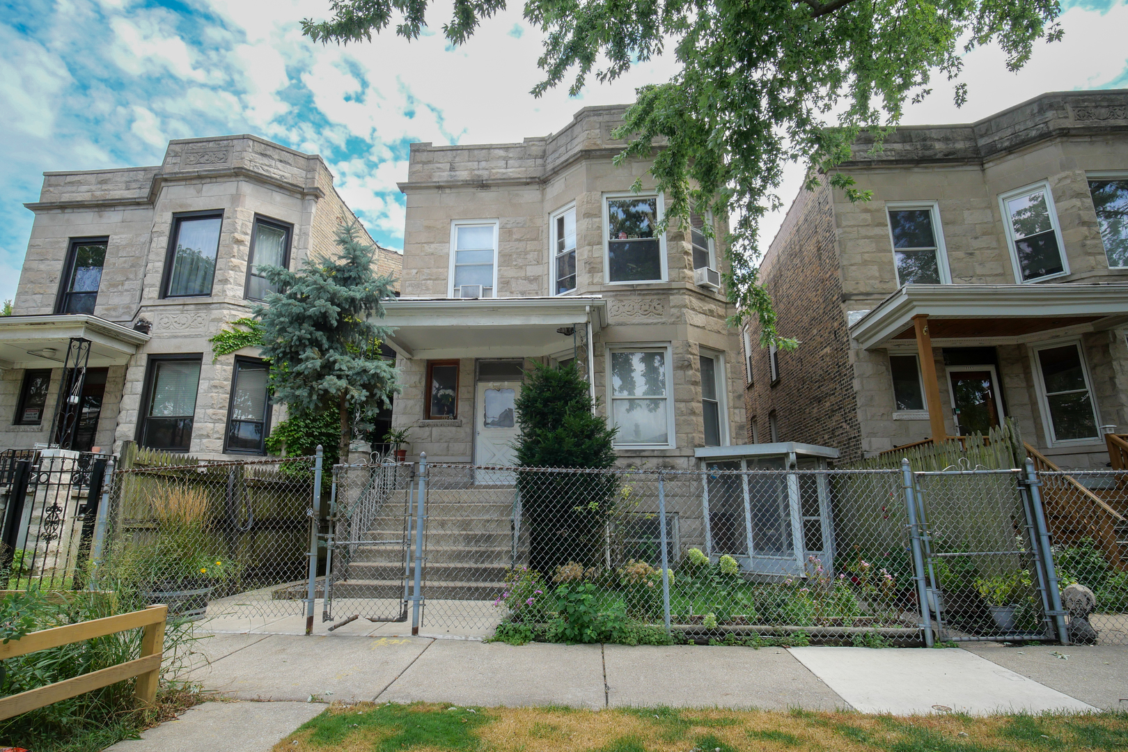 a front view of a house with a garden