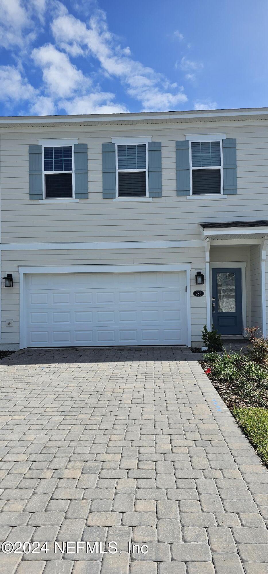 a front view of a house with yard