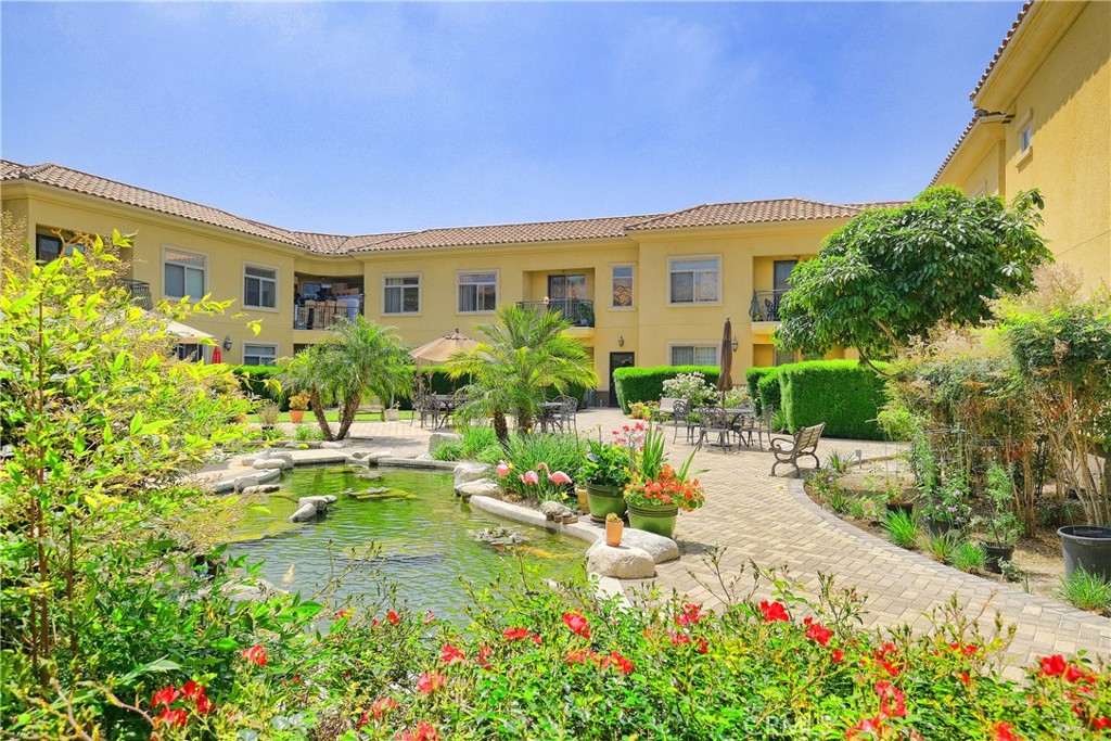 a view of a house with swimming pool and a garden