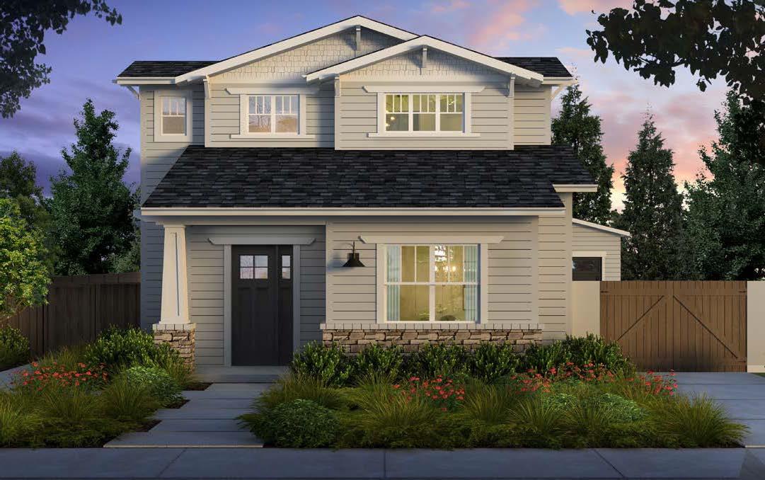 a front view of a house with a yard and potted plants