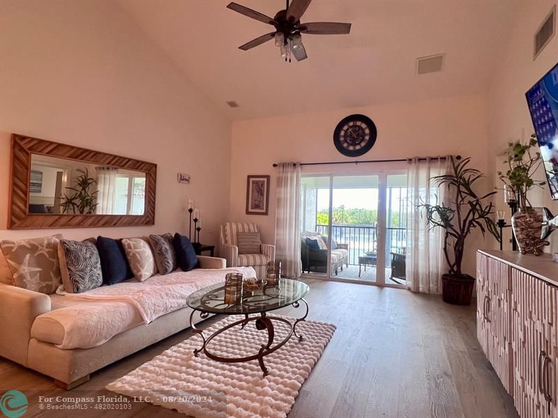 a living room with furniture a rug and a large window