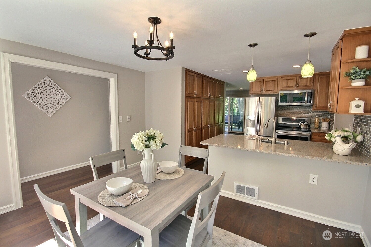 a view of a dining room with furniture and chandelier