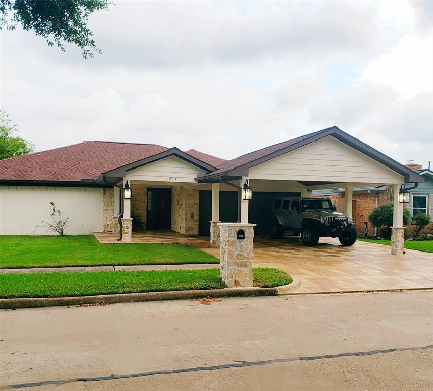 a front view of a house with a patio and a yard